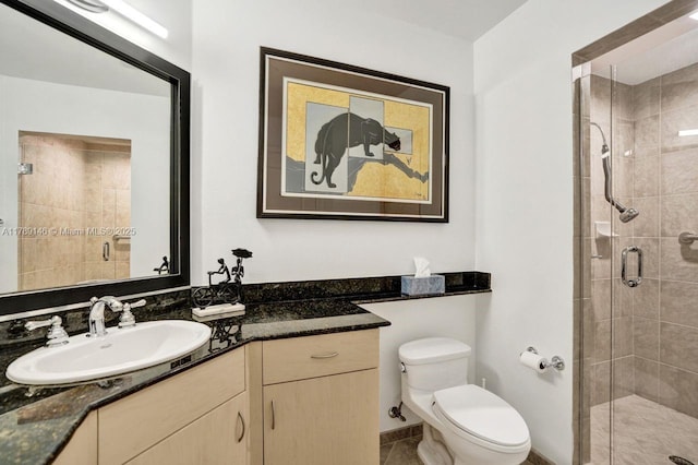 full bathroom with vanity, tile patterned floors, a stall shower, and toilet