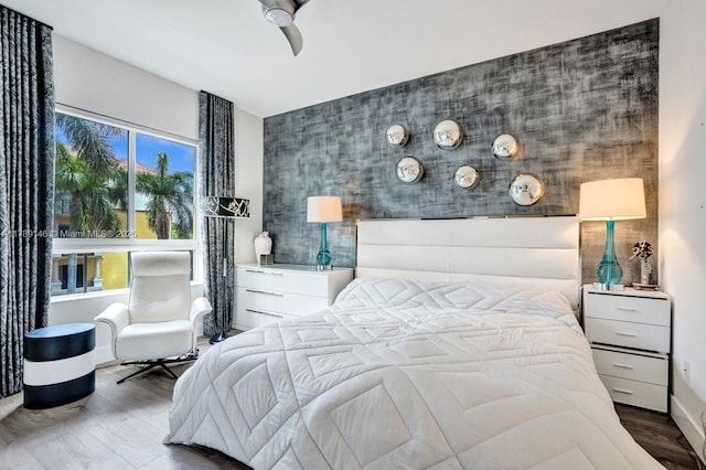 16101 Emerald Estates Dr Unit 342, Weston, FL 33331 - bedroom featuring a ceiling fan, an accent wall, and wood finished floors