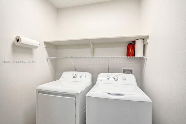 washroom featuring laundry area and washer and clothes dryer