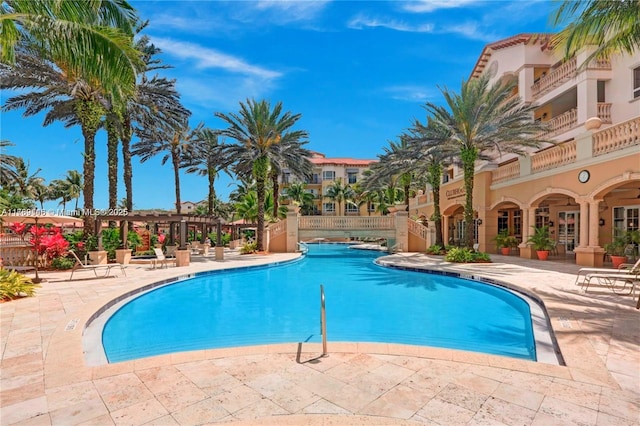 community pool with a patio and a pergola