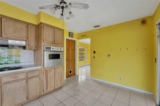 kitchen with oven, electric stovetop, decorative backsplash, a ceiling fan, and under cabinet range hood