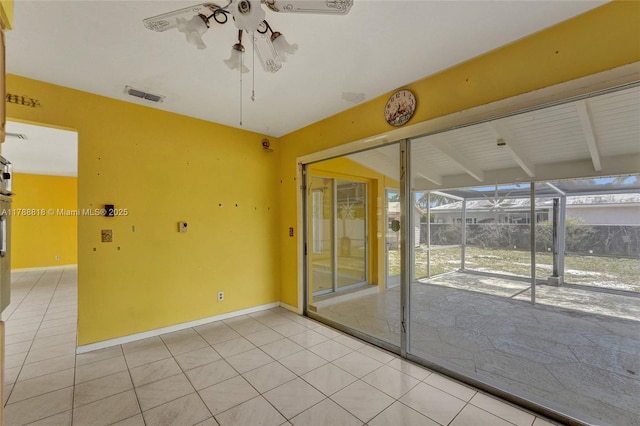 empty room with visible vents, light tile patterned floors, beam ceiling, a sunroom, and ceiling fan