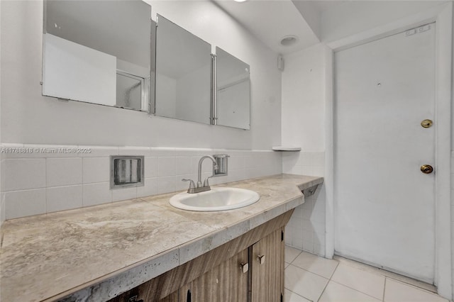 bathroom with vanity, tile patterned floors, a wainscoted wall, and tile walls