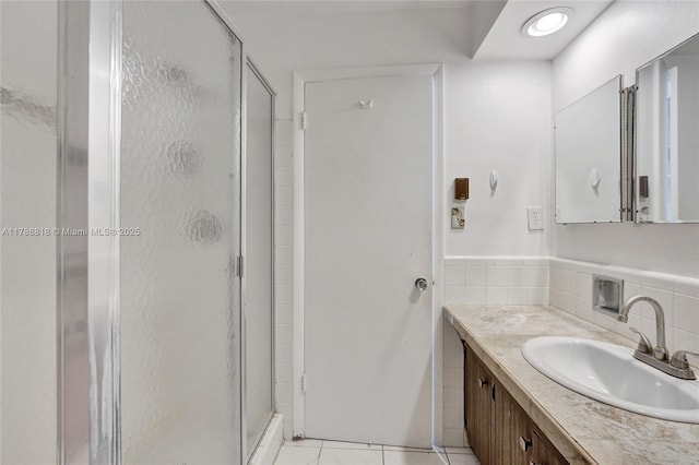 full bathroom featuring vanity, tile patterned floors, and a stall shower