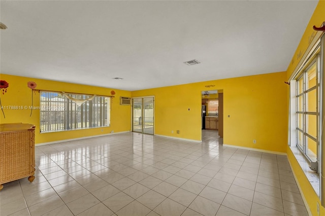 spare room with baseboards, visible vents, and light tile patterned floors