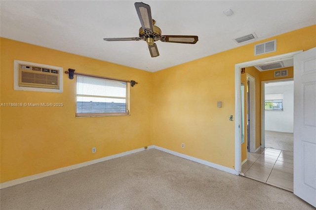 unfurnished room with baseboards, visible vents, ceiling fan, and a wall mounted air conditioner