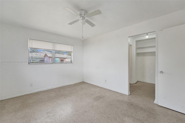 unfurnished bedroom with speckled floor, a ceiling fan, and baseboards