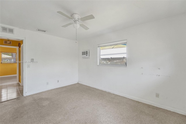 spare room featuring baseboards, visible vents, and ceiling fan