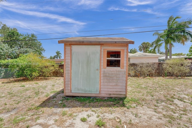 view of shed featuring fence