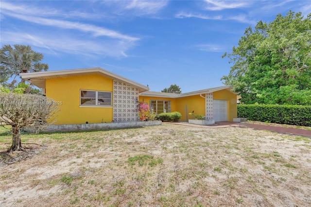 view of front of house featuring an attached garage and stucco siding