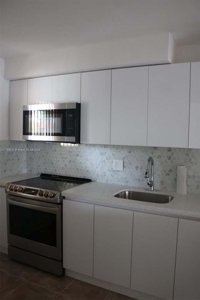 3490 Foxcroft Rd Unit B304, Miramar, FL 33025 - kitchen with stainless steel appliances, a sink, modern cabinets, white cabinetry, and light countertops
