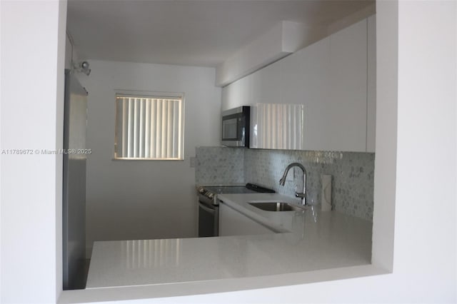 3490 Foxcroft Rd Unit B304, Miramar, FL 33025 - kitchen featuring appliances with stainless steel finishes, a sink, and backsplash