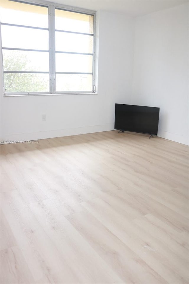 3490 Foxcroft Rd Unit B304, Miramar, FL 33025 - empty room featuring plenty of natural light, wood finished floors, and baseboards