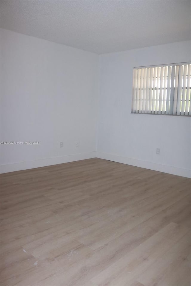 3490 Foxcroft Rd Unit B304, Miramar, FL 33025 - spare room with wood finished floors and baseboards