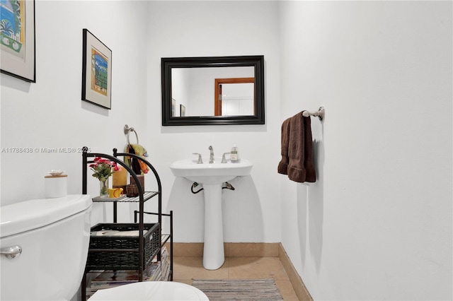3730 Kumquat Ave, Miami, FL 33133 - half bathroom featuring toilet, tile patterned flooring, and baseboards