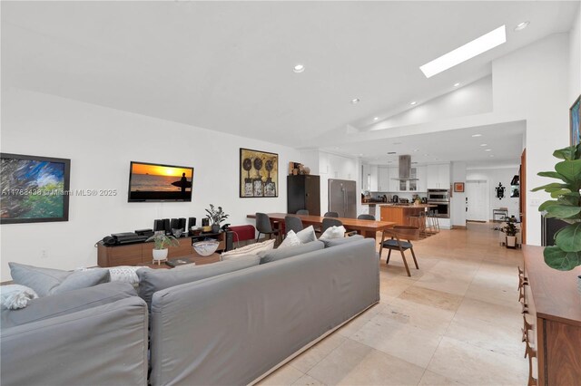 3730 Kumquat Ave, Miami, FL 33133 - living room featuring a skylight, recessed lighting, light tile patterned floors, and high vaulted ceiling