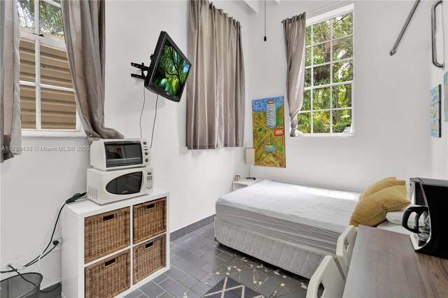 3730 Kumquat Ave, Miami, FL 33133 - bedroom with dark tile patterned floors