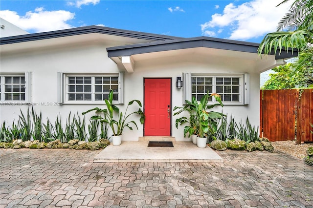 3730 Kumquat Ave, Miami, FL 33133 - view of exterior entry with stucco siding and fence