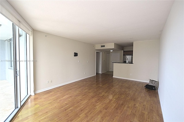 335 S Biscayne Blvd Unit 1904, Miami, FL 33131 - unfurnished living room with wood finished floors and a textured ceiling