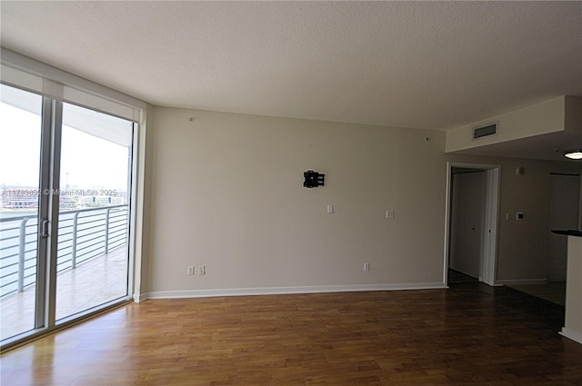 335 S Biscayne Blvd Unit 1904, Miami, FL 33131 - spare room with wood finished floors and a textured ceiling