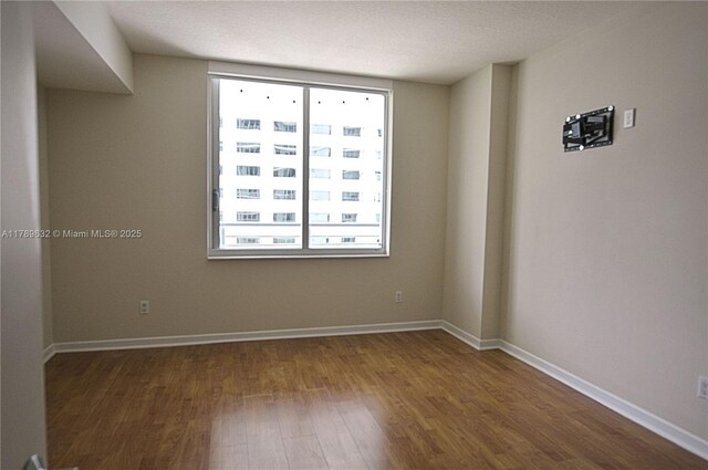 335 S Biscayne Blvd Unit 1904, Miami, FL 33131 - unfurnished room with wood finished floors and baseboards
