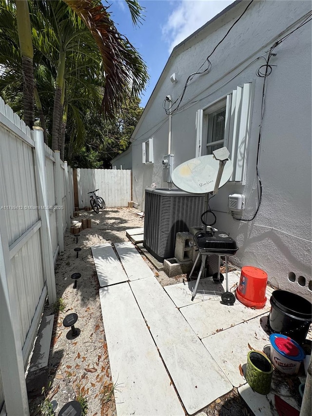view of patio / terrace featuring central air condition unit and a fenced backyard