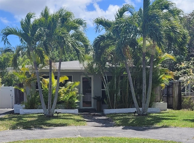 obstructed view of property featuring stucco siding and fence