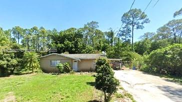 view of property exterior featuring a yard and driveway