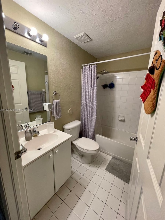 full bath featuring tile patterned flooring, a textured wall, visible vents, toilet, and a textured ceiling