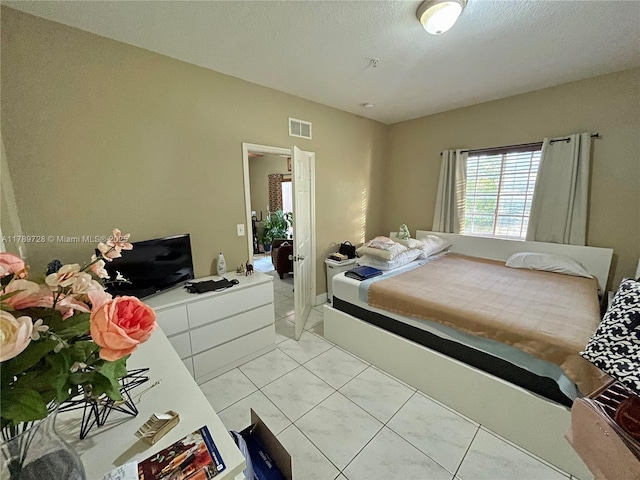 bedroom featuring visible vents and marble finish floor