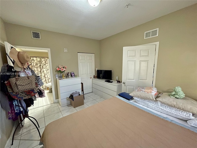 bedroom featuring visible vents and light tile patterned floors