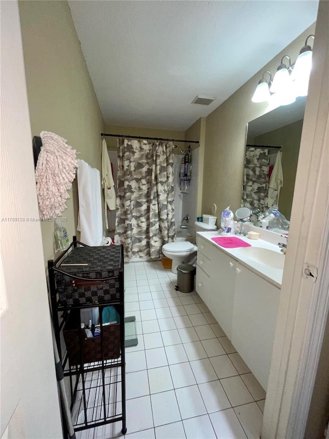 full bathroom featuring tile patterned floors, toilet, visible vents, shower / tub combo, and vanity