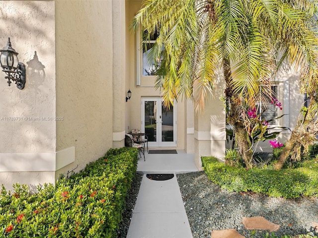 1206 Falls Blvd, Weston, FL 33327 - view of exterior entry featuring stucco siding and french doors