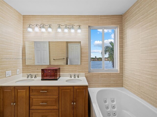 1206 Falls Blvd, Weston, FL 33327 - bathroom featuring a whirlpool tub, double vanity, and tile walls