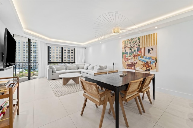 520 Brickell Key Dr Unit A713, Miami, FL 33131 - dining area featuring a raised ceiling, light tile patterned floors, baseboards, and recessed lighting