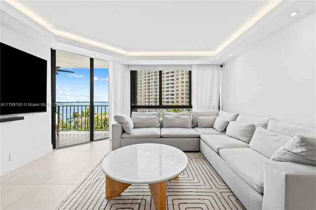 520 Brickell Key Dr Unit A713, Miami, FL 33131 - living room with light tile patterned floors, a raised ceiling, floor to ceiling windows, and recessed lighting