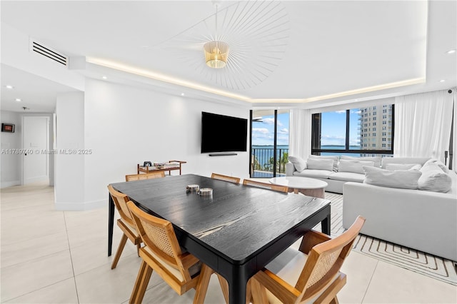 520 Brickell Key Dr Unit A713, Miami, FL 33131 - dining area with light tile patterned floors, a raised ceiling, baseboards, and recessed lighting