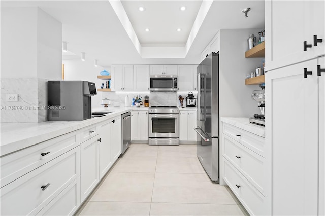 520 Brickell Key Dr Unit A713, Miami, FL 33131 - kitchen with open shelves, appliances with stainless steel finishes, light stone countertops, white cabinets, and recessed lighting
