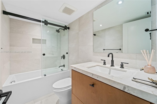 520 Brickell Key Dr Unit A713, Miami, FL 33131 - full bath with tile walls, vanity, toilet, combined bath / shower with glass door, and backsplash