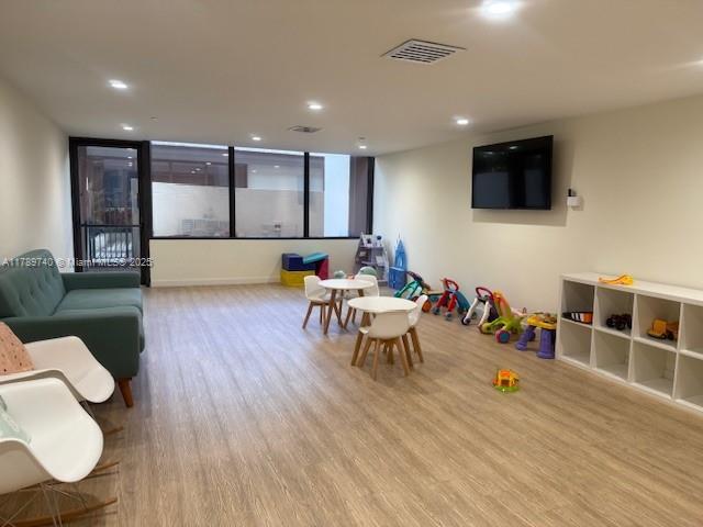 520 Brickell Key Dr Unit A713, Miami, FL 33131 - recreation room featuring wood finished floors and recessed lighting