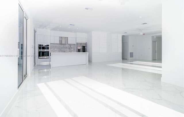 900 SW 24th Rd, Miami, FL 33129 - unfurnished living room with recessed lighting, visible vents, a sink, and marble finish floor