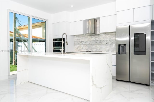900 SW 24th Rd, Miami, FL 33129 - kitchen with wall chimney range hood, stainless steel appliances, decorative backsplash, and a wealth of natural light