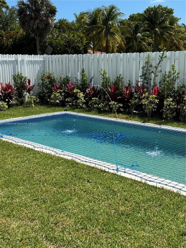 900 SW 24th Rd, Miami, FL 33129 - view of pool featuring a lawn, fence, and a fenced in pool