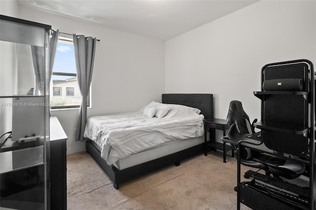 bedroom with light carpet and baseboards