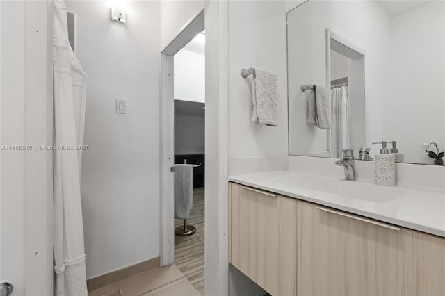 bathroom featuring vanity and wood finished floors