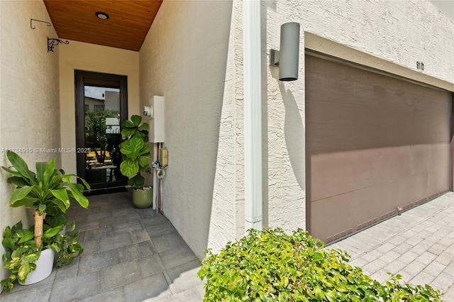 property entrance with stucco siding