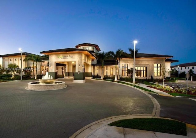 view of front of house with curved driveway