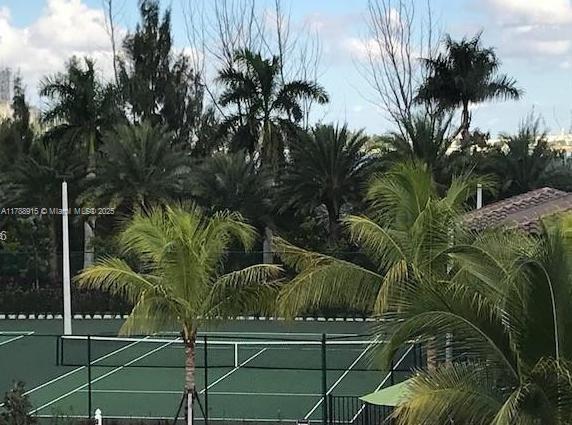 view of sport court featuring fence