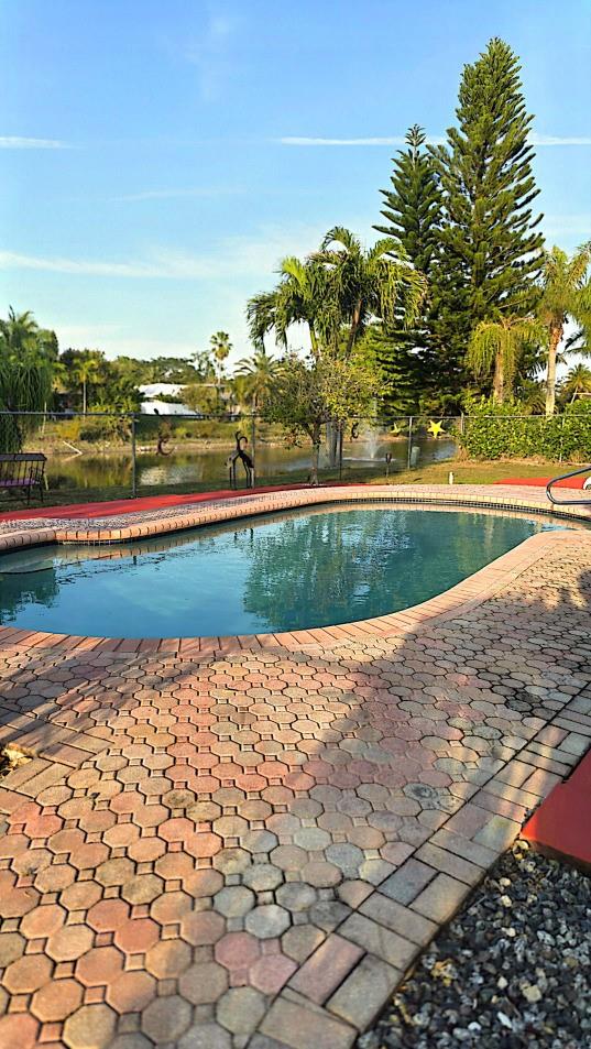 pool with a patio and fence