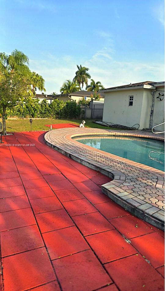 view of swimming pool with a fenced in pool and fence